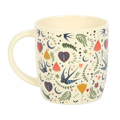 Tasse hirondelle et fleurs